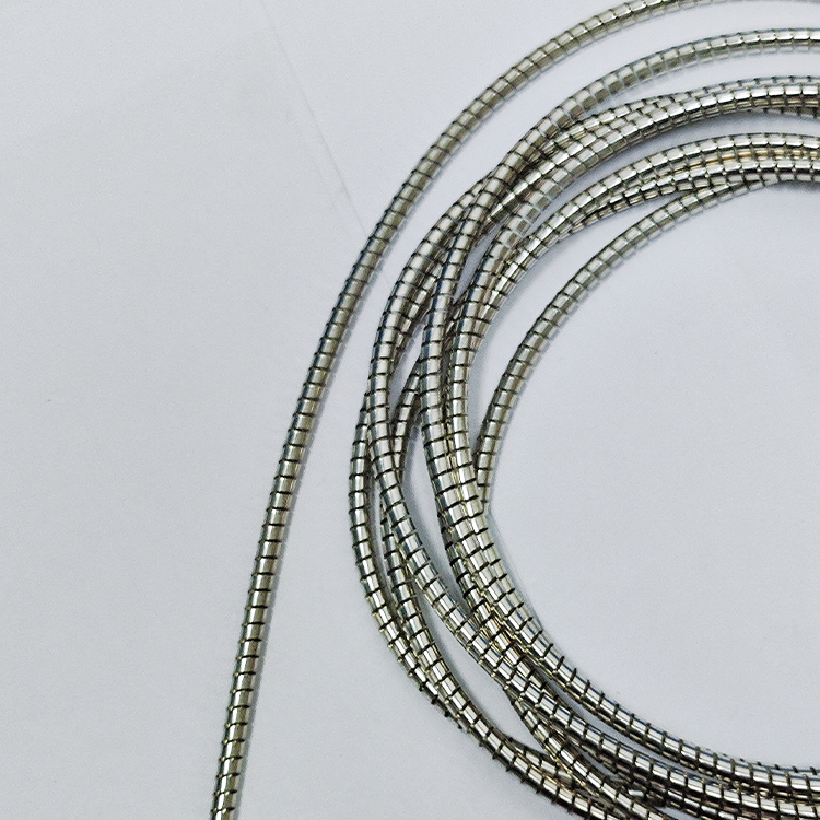 How often should lubrication be applied to helical compression springs?