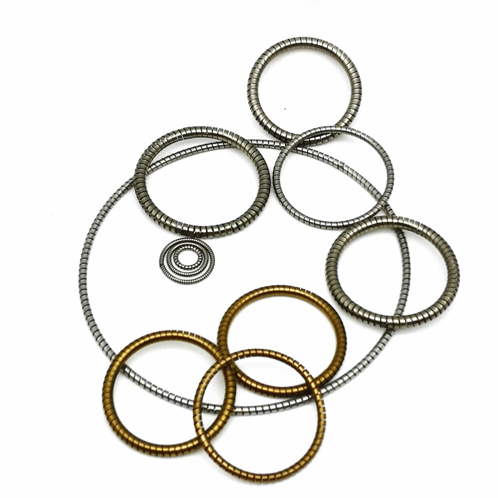 Helical springs for spring energized seals